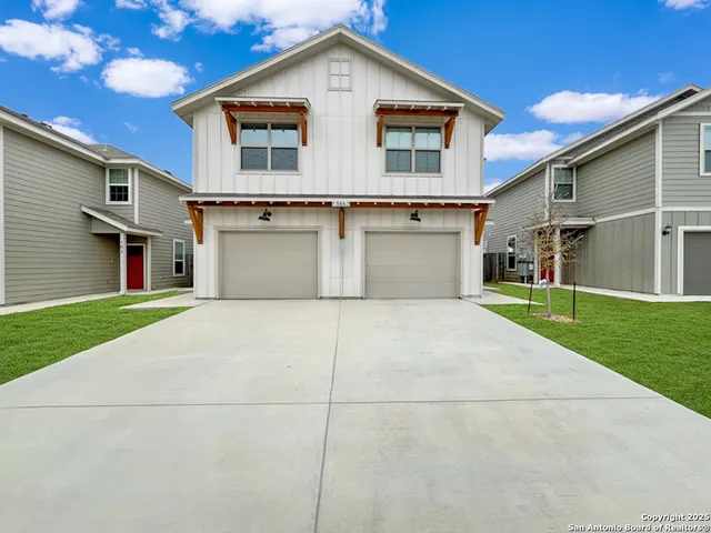 a view of a white house with a yard