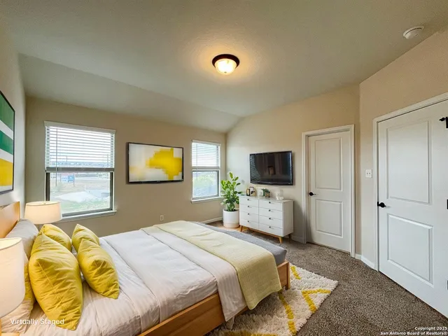 a bedroom with a bed and a couch