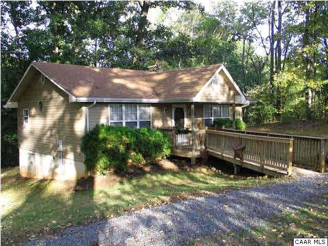 5619 Fredericksburg Road Ruckersville, VA 22968 - Photo 29 of 29 a backyard of a house with a yard table and chairs