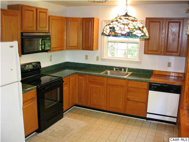 5619 Fredericksburg Road Ruckersville, VA 22968 - Photo 6 of 29 a kitchen with granite countertop stainless steel appliances a stove a sink and a microwave