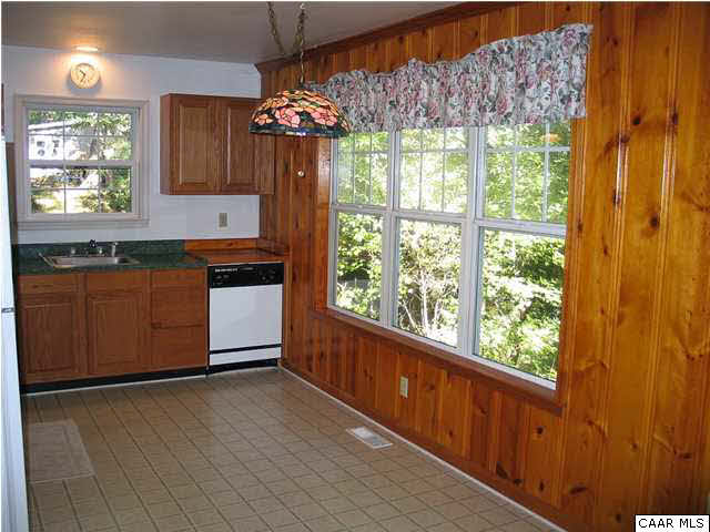 5619 Fredericksburg Road Ruckersville, VA 22968 - Photo 7 of 29 a kitchen with granite countertop a stove and a wooden cabinets