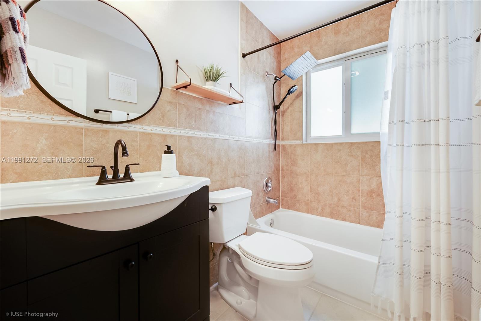 8535 Southwest 97th Road Miami, FL 33173 - Photo 16 of 28 a bathroom with a sink a mirror a toilet and a shower