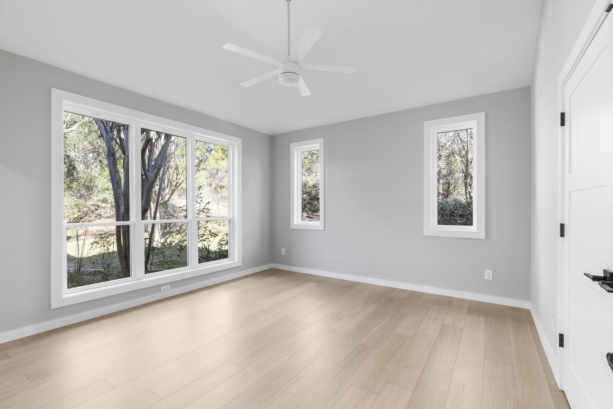 701 Furlong Drive Austin, TX 78746 - Photo 23 of 40 a view of an empty room with a window and wooden floor