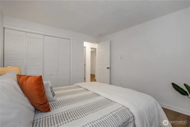 a bedroom with a bed and a night stand