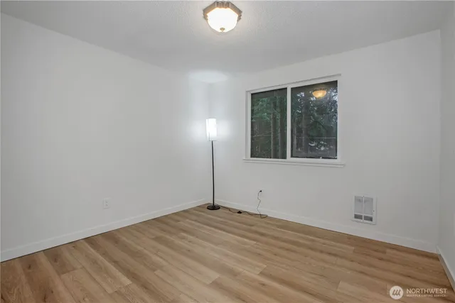 a view of an empty room and wooden floor