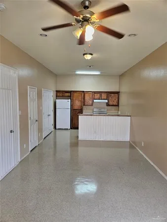 a view of a livingroom with a ceiling fan and window