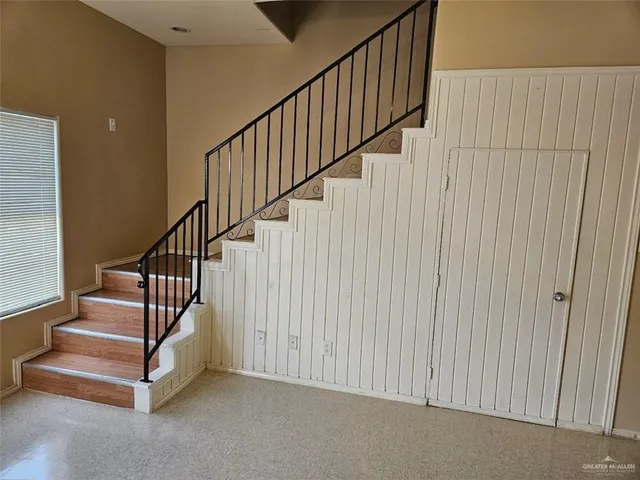 a view of staircase with white walls and a window