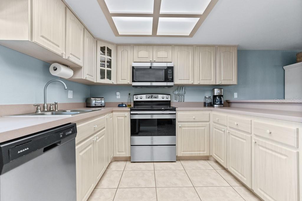 100 Ingrid Place Oldsmar, FL 34677 - Photo 11 of 51 a kitchen with cabinets appliances a sink and a window