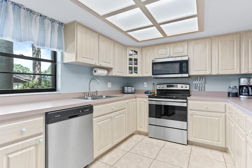 100 Ingrid Place Oldsmar, FL 34677 - Photo 12 of 51 a kitchen with appliances a sink and cabinets