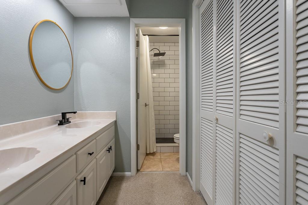 100 Ingrid Place Oldsmar, FL 34677 - Photo 21 of 51 a bathroom with a granite countertop sink and a mirror