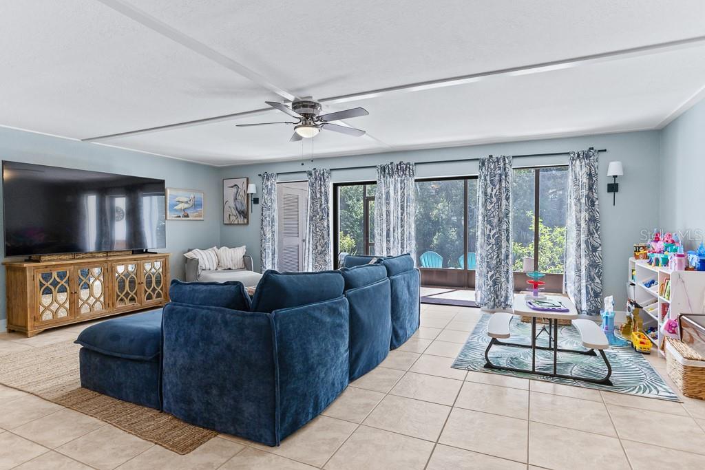 100 Ingrid Place Oldsmar, FL 34677 - Photo 5 of 51 a living room with furniture and a flat screen tv
