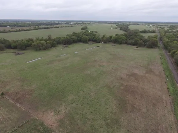 a view of a field with an ocean