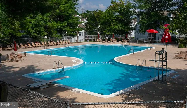 a view of a swimming pool with an outdoor seating