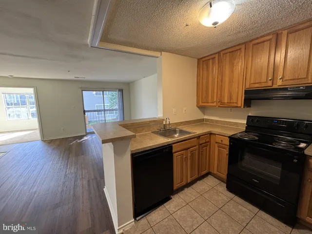 a kitchen with stainless steel appliances granite countertop a stove and a sink