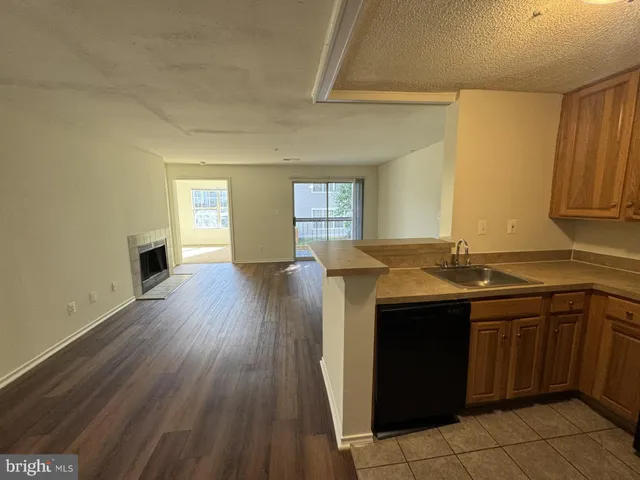a kitchen with granite countertop a sink and cabinets