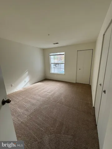 a view of an empty room and a window