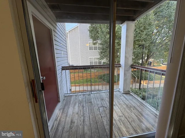 a view of a room with wooden floor and floor to ceiling window