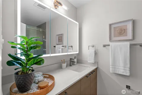 a bathroom with a sink a toilet and a mirror