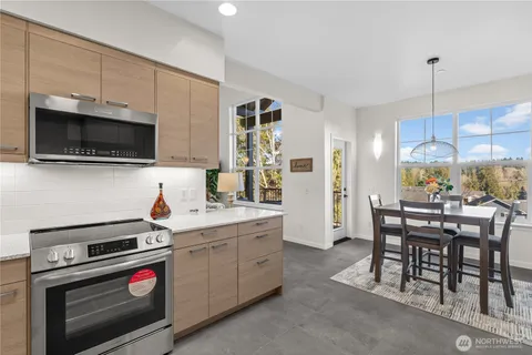 a kitchen with a sink a stove and chairs
