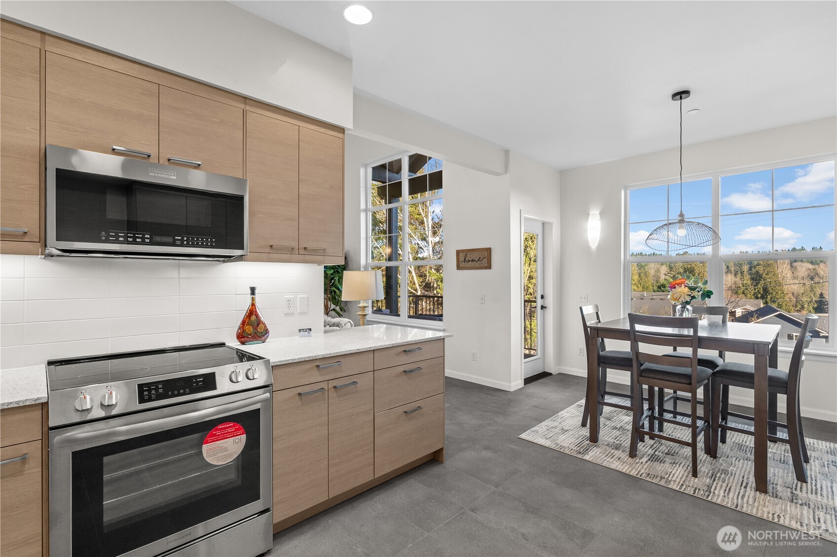 23202 Fitzgerald Road, Unit 1 Bothell, WA 98021 - Photo 6 of 21 a kitchen with a sink a stove and chairs