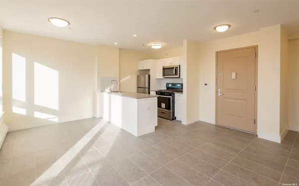a view of a kitchen with a sink and a refrigerator