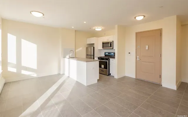 a view of a kitchen with a sink and a refrigerator