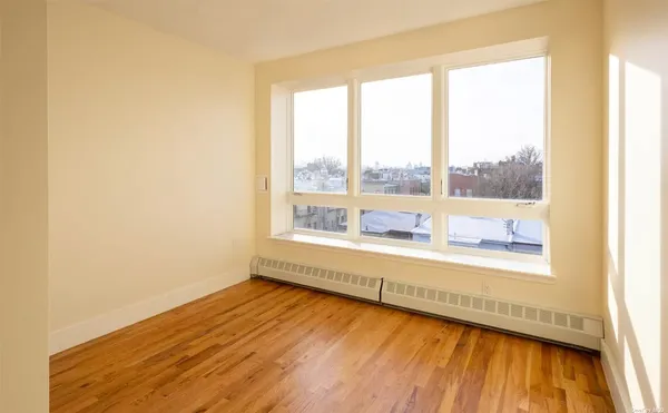 a view of an empty room and wooden floor