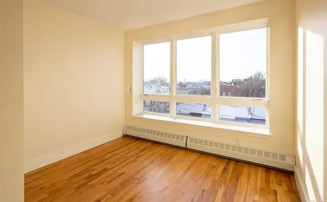 a view of an empty room and wooden floor