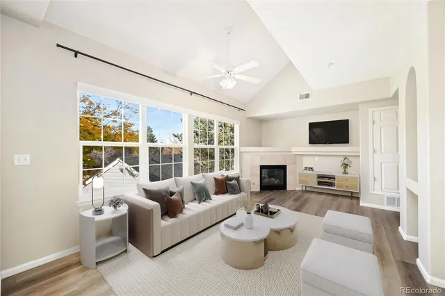 a living room with furniture a fireplace and a flat screen tv