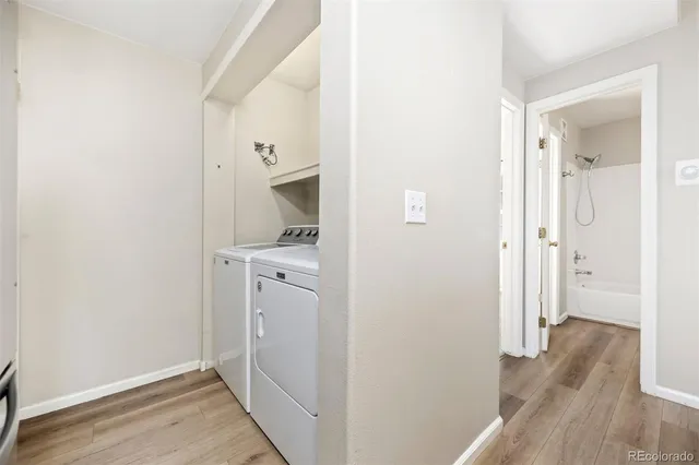 a view of a hallway with wooden floor and closet