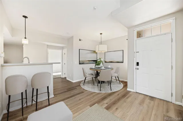 a view of a dining room with furniture and wooden floor