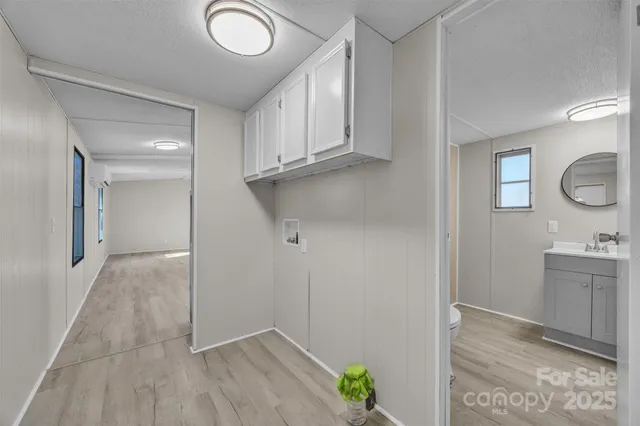 a view of cabinets with wooden floor and window
