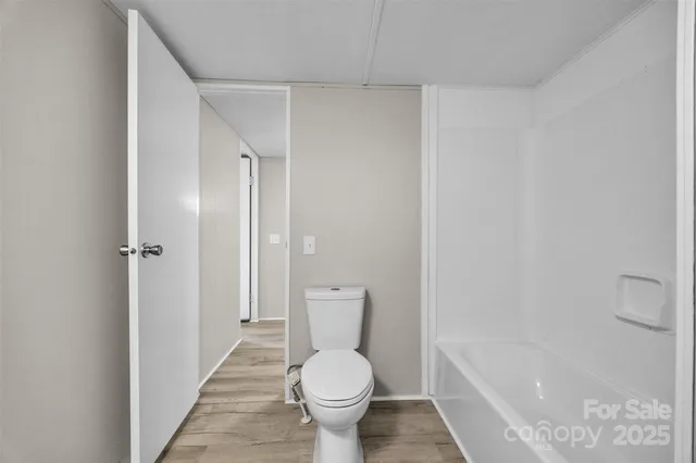 a bathroom with a toilet and a shower