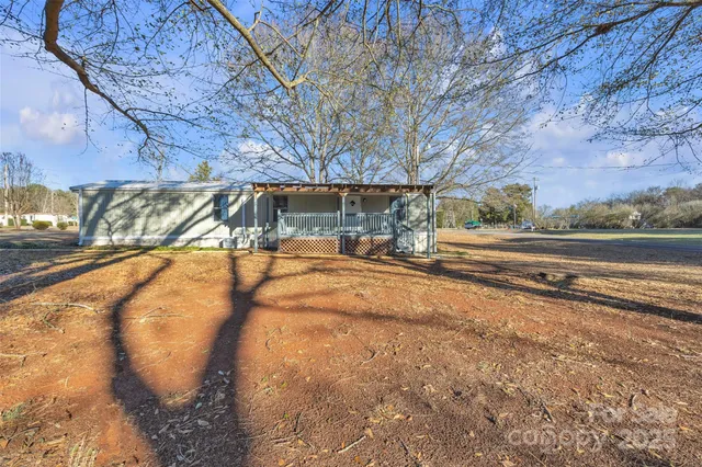 a view of backyard with large trees