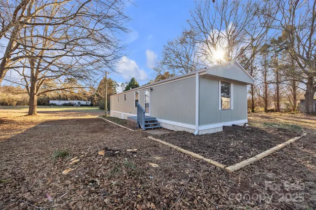 a view of a backyard with large trees