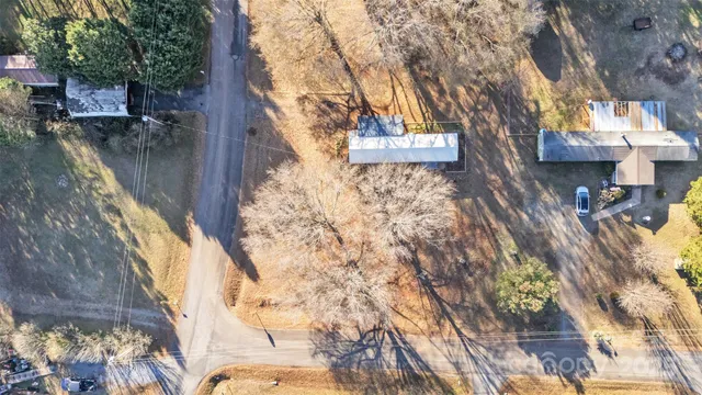 a backyard of a building with large trees