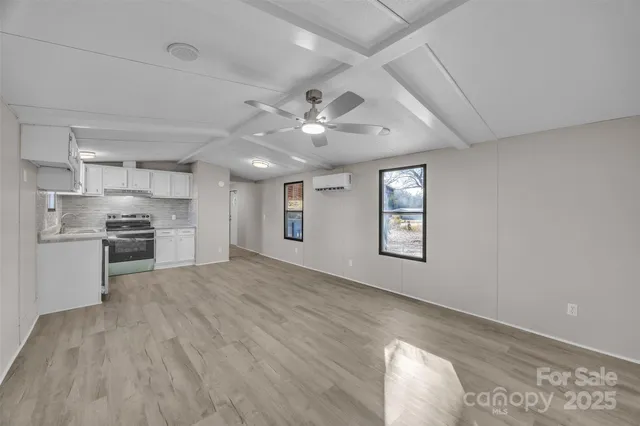 a view of kitchen with sink and refrigerator