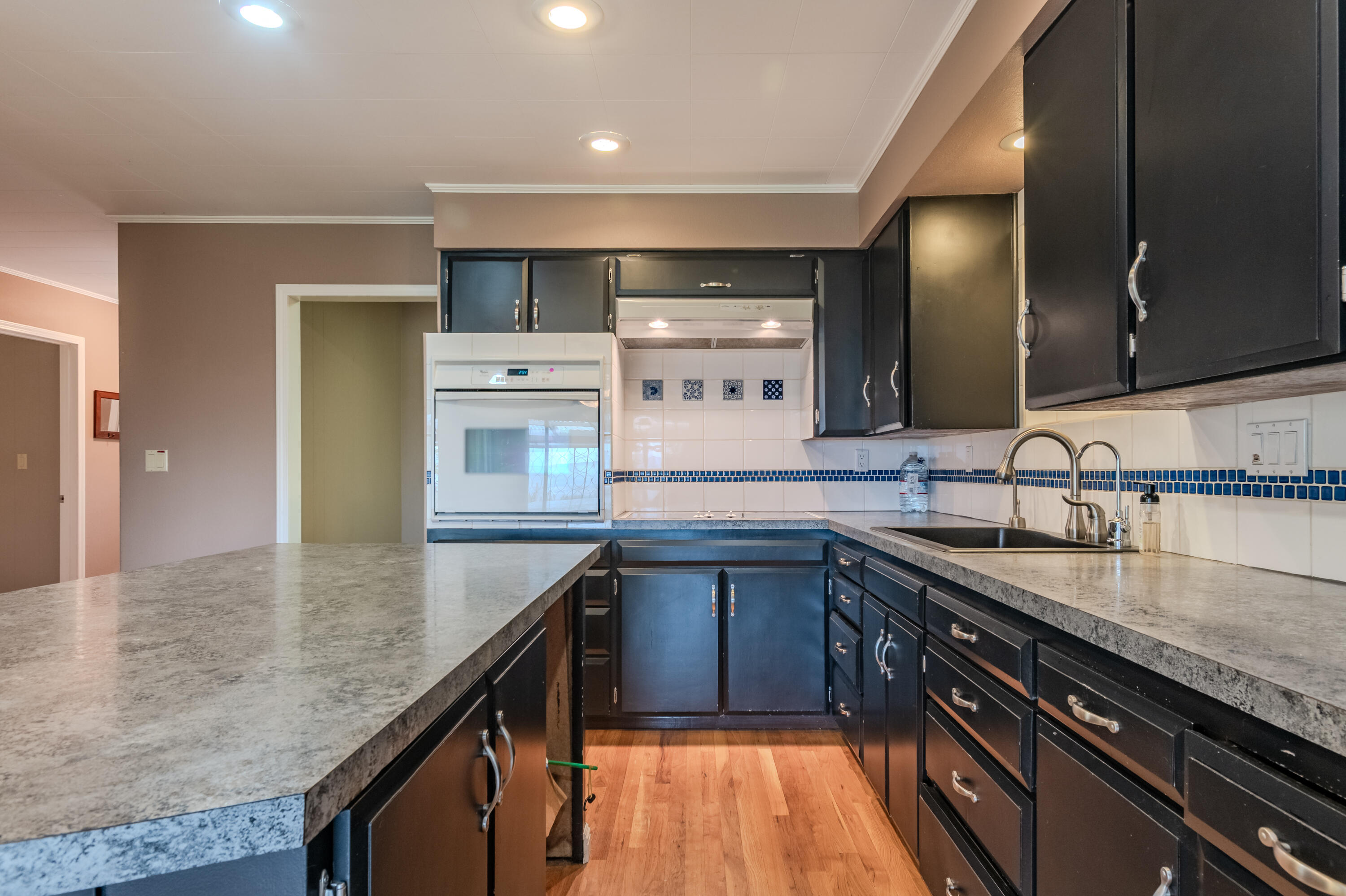 8192 Yank Gulch Road Talent, OR 97540 - Photo 7 of 34 a kitchen with kitchen island granite countertop a sink stove and cabinets