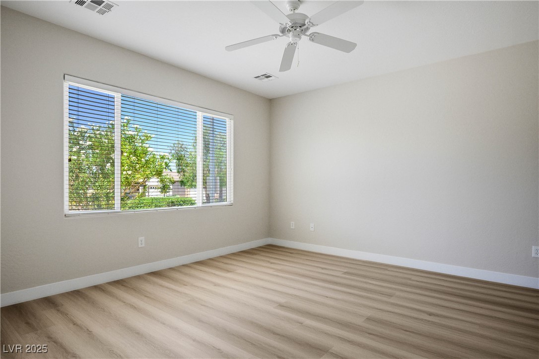 2563 Sargon Street Henderson, NV 89044 - Photo 15 of 35 Unfurnished room featuring light wood-style flooring and ceiling fan