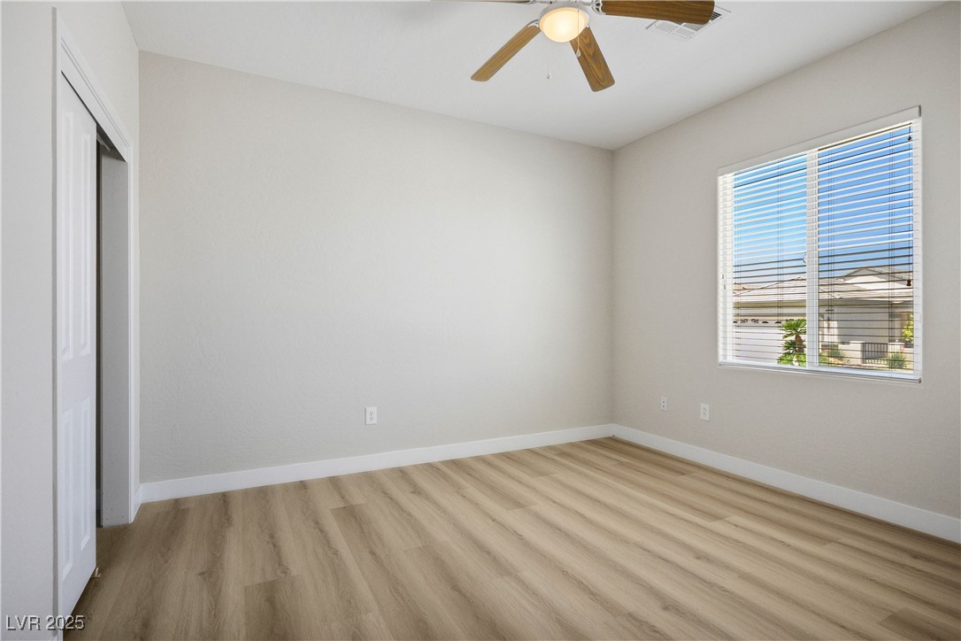 2563 Sargon Street Henderson, NV 89044 - Photo 20 of 35 Unfurnished bedroom featuring light wood finished floors, a closet, and a ceiling fan