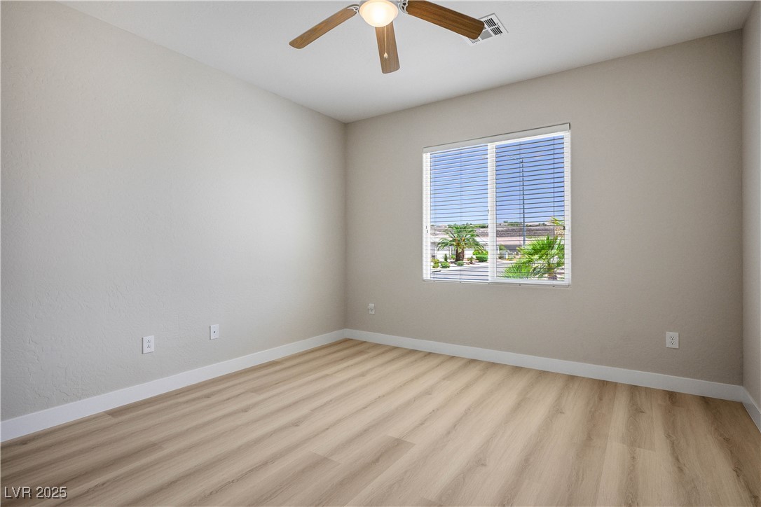 2563 Sargon Street Henderson, NV 89044 - Photo 21 of 35 Unfurnished room with wood finished floors and ceiling fan