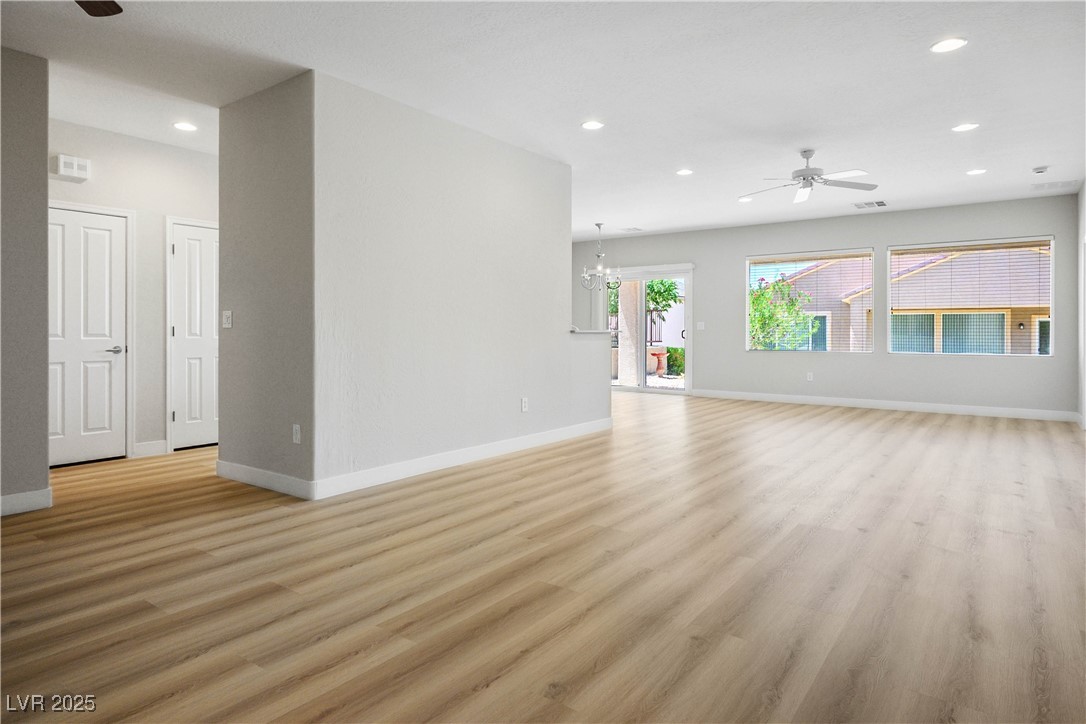 2563 Sargon Street Henderson, NV 89044 - Photo 5 of 35 Unfurnished living room with ceiling fan, recessed lighting, light wood finished floors, and a chandelier