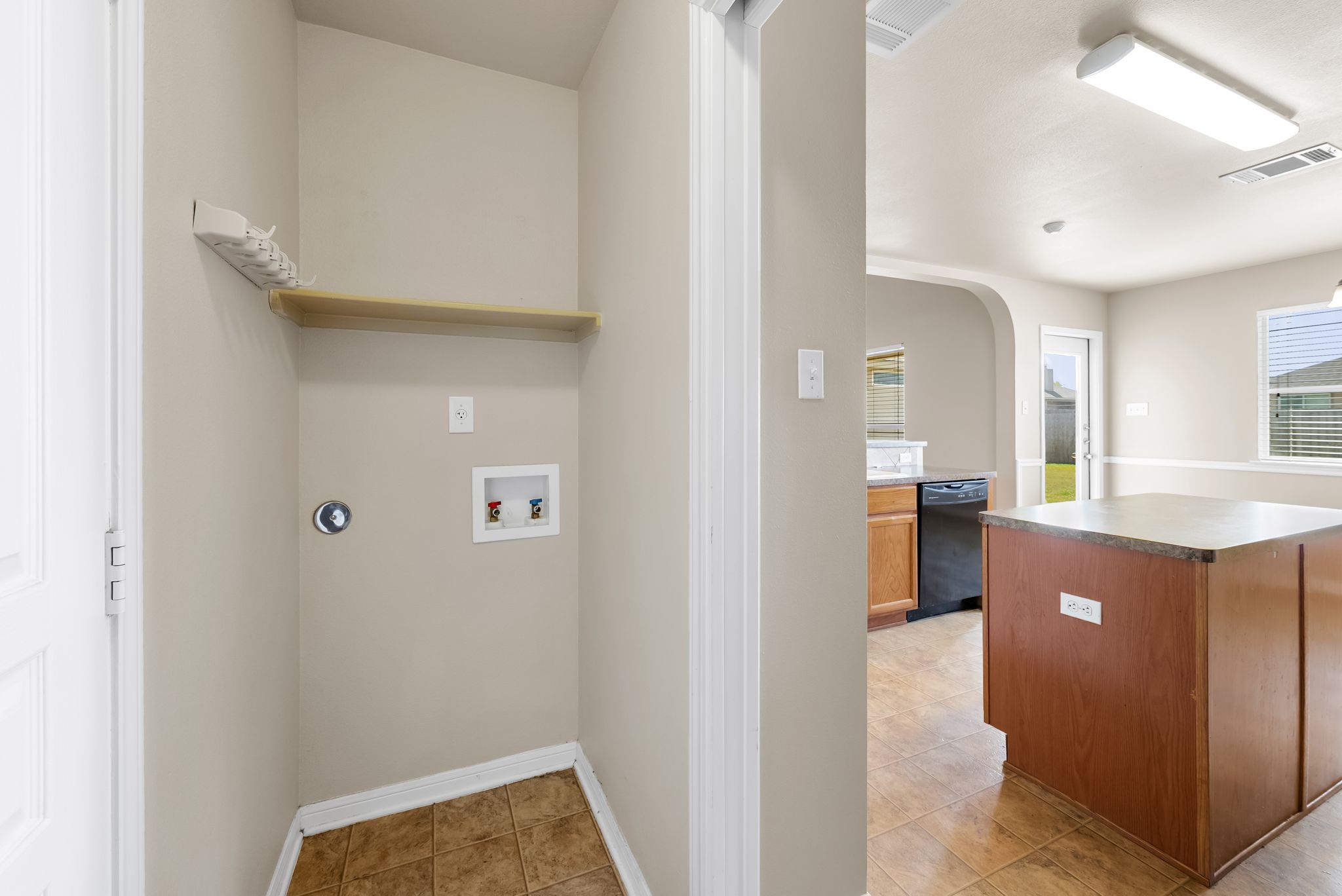 7719 Fieldstone Drive Temple, TX 76502 - Photo 22 of 37 Laundry area with arched walkways, hookup for a washing machine, and light tile patterned flooring