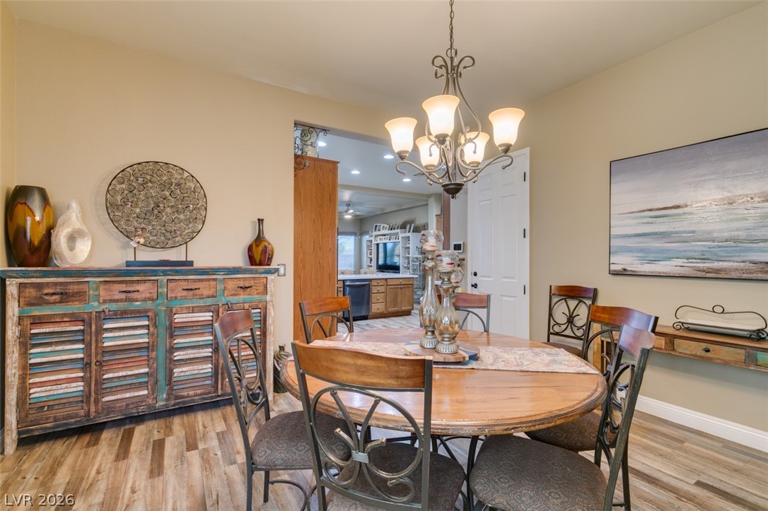 7524 Midnight Rambler Street Las Vegas, NV 89149 - Photo 26 of 51 An inviting dining area features durable flooring, a decorative chandelier, and an adjacent kitchen view.