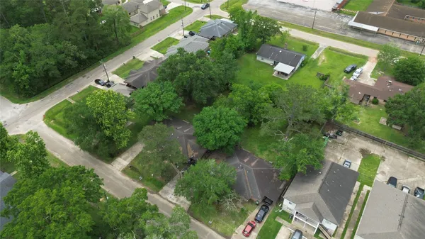 an aerial view of residential house with outdoor space and trees all around