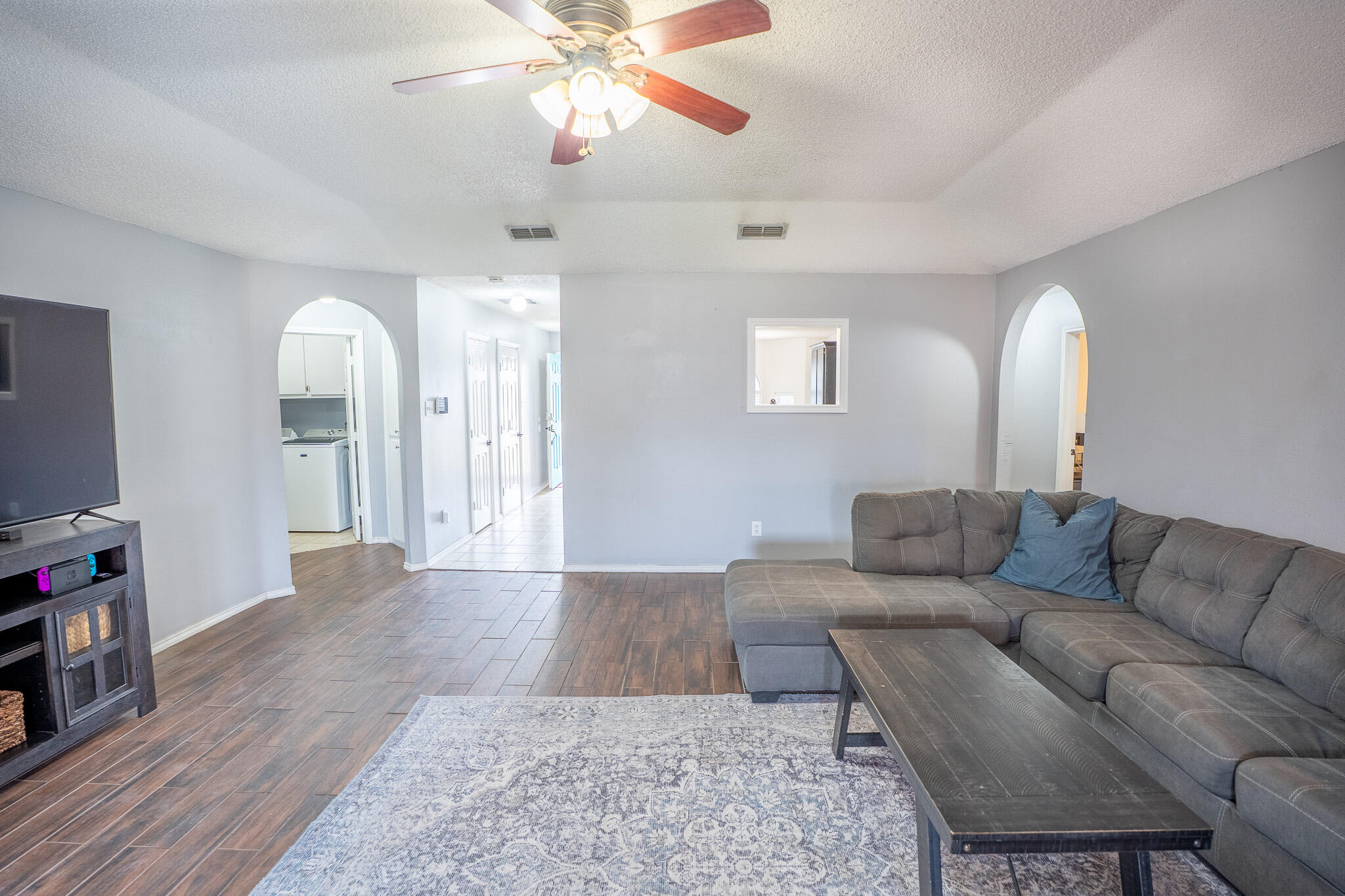 1609 78th Street Lubbock, TX 79423 - Photo 6 of 36 a living room with furniture and a flat screen tv