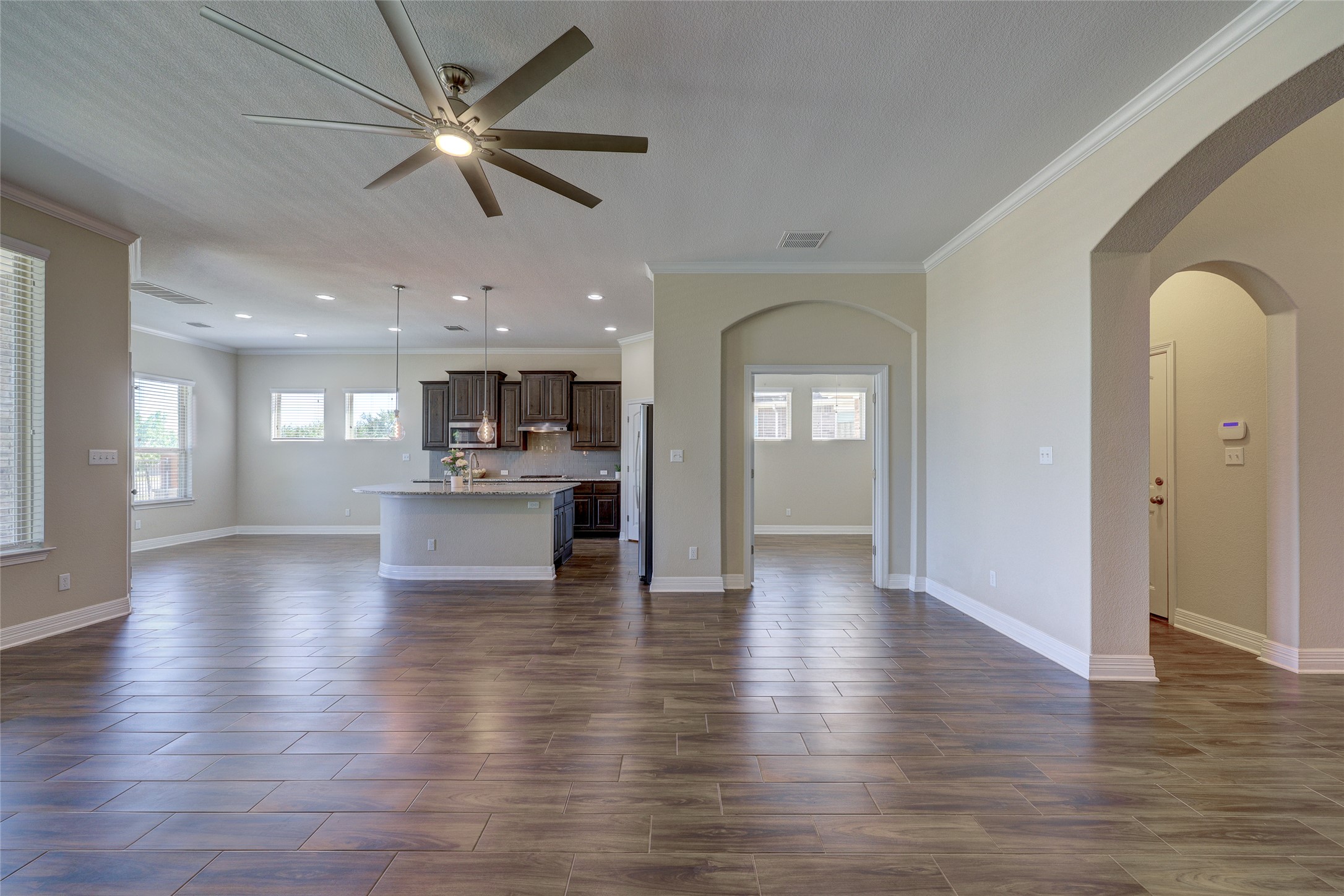 409 Betony Loop Buda, TX 78610 - Photo 38 of 38 An inviting open floorplan seamlessly connects a well-appointed kitchen to a spacious living area.