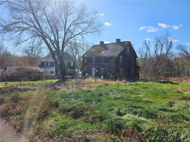 a view of a backyard with large trees