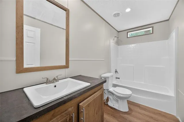 a bathroom with a sink toilet a mirror and shower