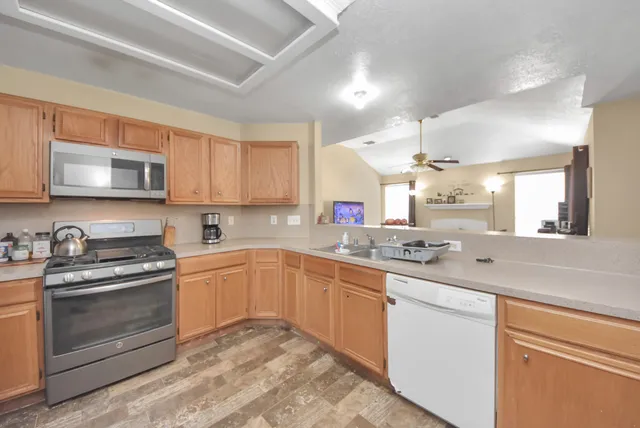 a kitchen with stainless steel appliances granite countertop a sink and cabinets
